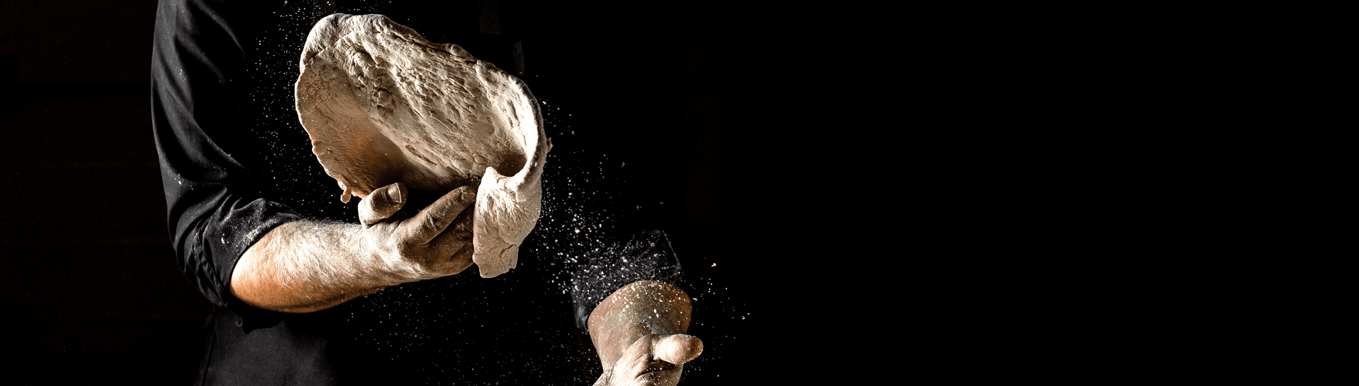 Chef Tossing Fresh Pizza Dough at Luigi's Pizzeria